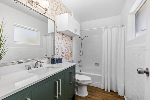 full bathroom with wood-type flooring, shower / bathtub combination with curtain, vanity, and toilet