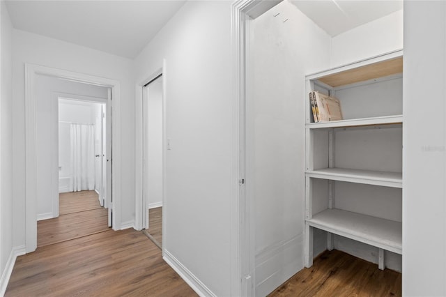 corridor featuring hardwood / wood-style floors