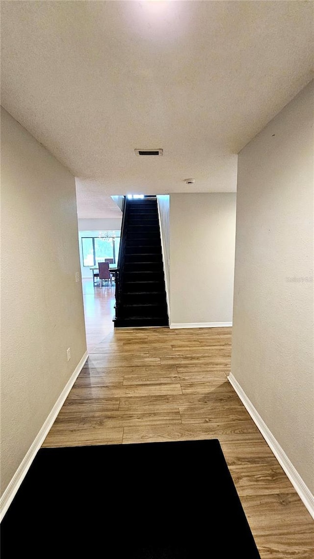 corridor featuring hardwood / wood-style floors