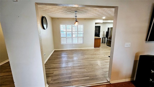 unfurnished dining area with light wood-type flooring