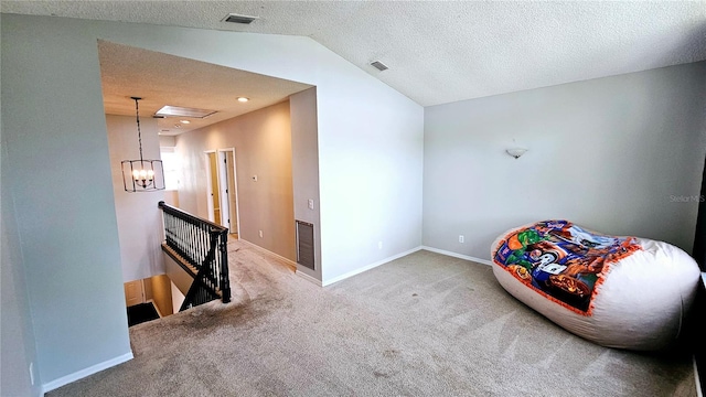 unfurnished room with vaulted ceiling, carpet floors, a chandelier, and a textured ceiling