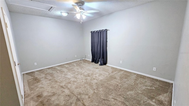 spare room with light carpet and a textured ceiling