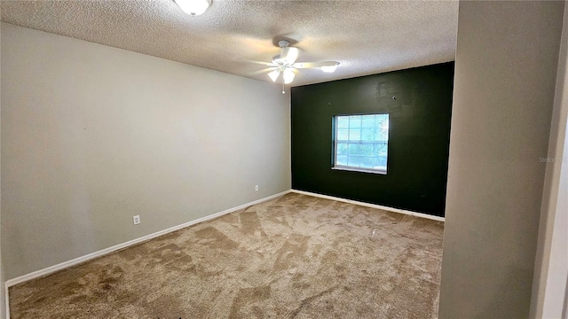 carpeted spare room featuring a textured ceiling