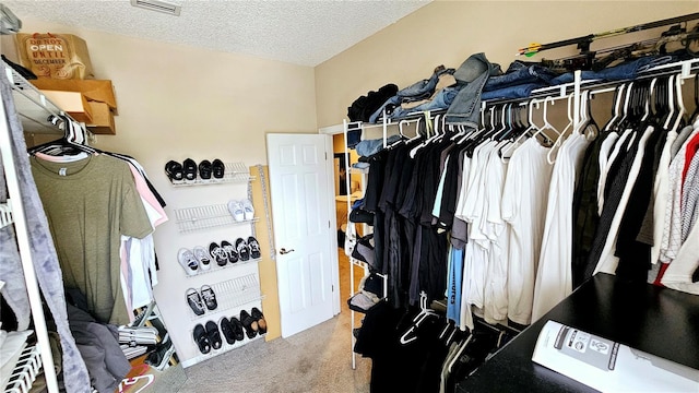 walk in closet featuring carpet flooring