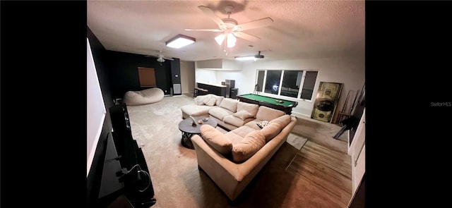 home theater room featuring pool table, a textured ceiling, ceiling fan, and carpet