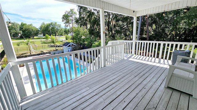 deck featuring a fenced in pool