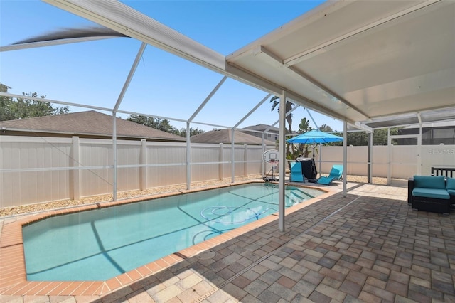 view of pool featuring a patio and glass enclosure