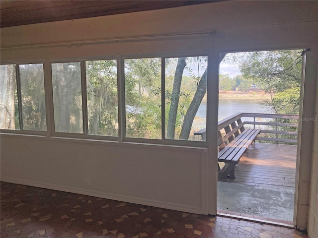 unfurnished sunroom with a water view