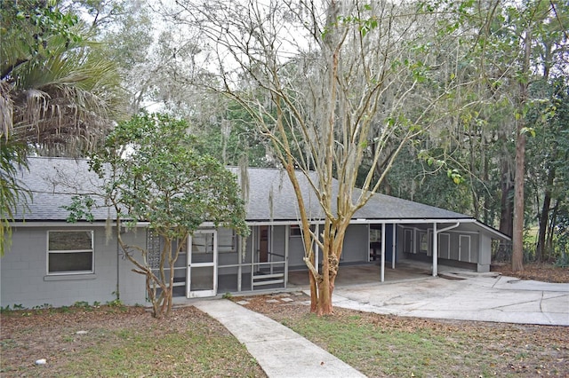 view of front of home featuring a sunroom and a carport