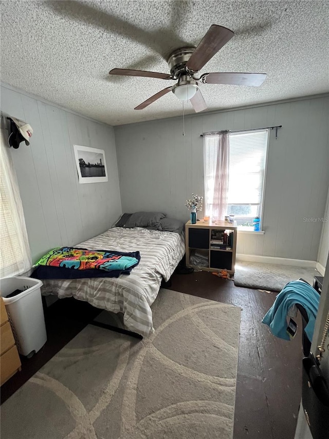 120 NW 9th St, Gainesville, FL 32601 - bedroom featuring wood finished floors, ceiling fan, and a textured ceiling