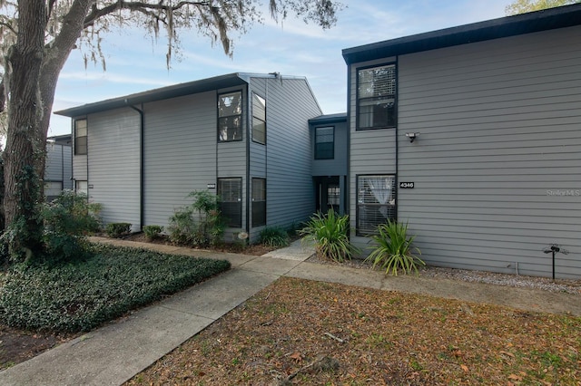 view of side of property with a lawn