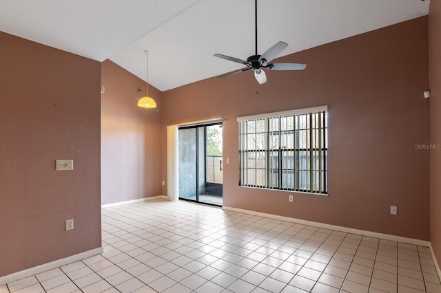 tiled spare room with ceiling fan and high vaulted ceiling