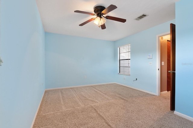 spare room with carpet and ceiling fan