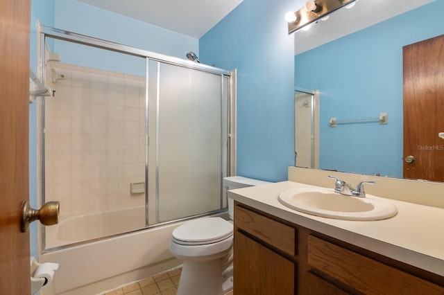 full bathroom with vanity, enclosed tub / shower combo, and toilet