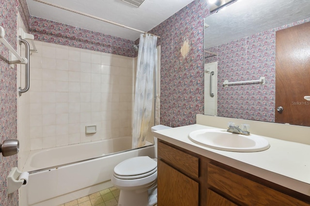 full bathroom featuring vanity, toilet, shower / bath combo with shower curtain, and a textured ceiling