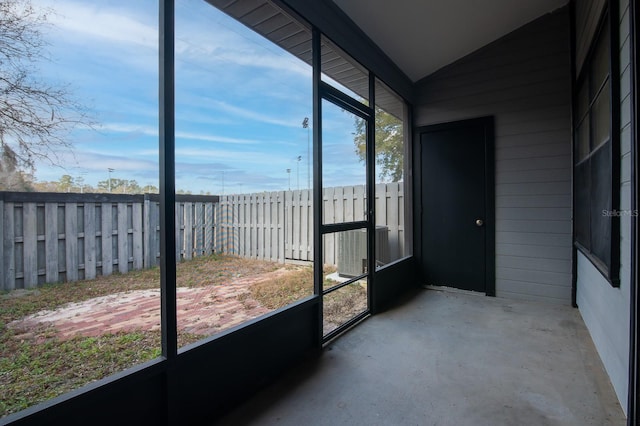 unfurnished sunroom featuring lofted ceiling