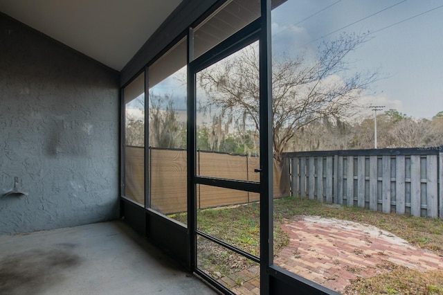 unfurnished sunroom with lofted ceiling