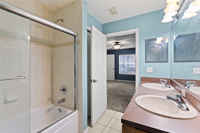 bathroom with tile patterned flooring, enclosed tub / shower combo, vanity, and an inviting chandelier