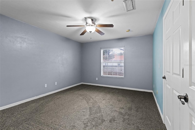 spare room with ceiling fan and carpet