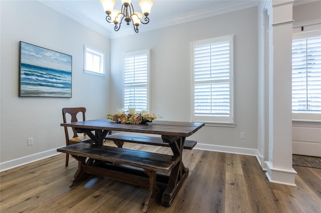 dining room with ornamental molding, a healthy amount of sunlight, baseboards, and wood finished floors