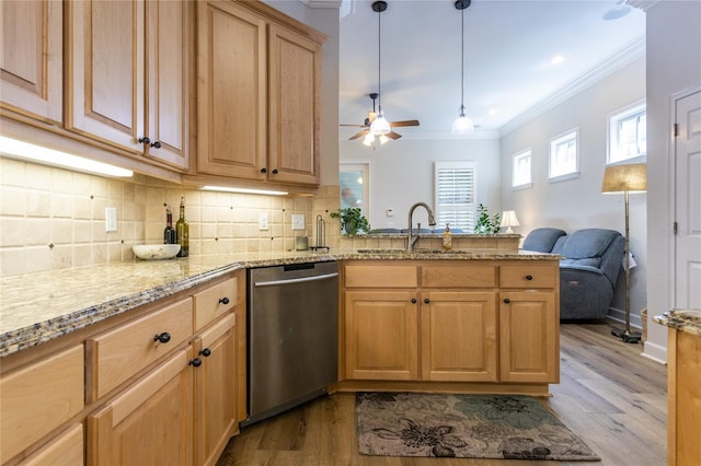 kitchen with crown molding, backsplash, a sink, dishwasher, and a peninsula