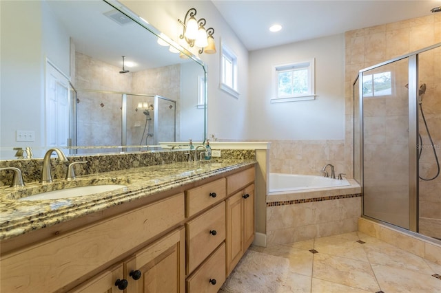 full bathroom with double vanity, a stall shower, and a sink