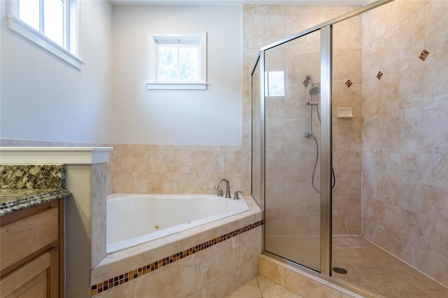 full bath featuring a stall shower, vanity, and a bath