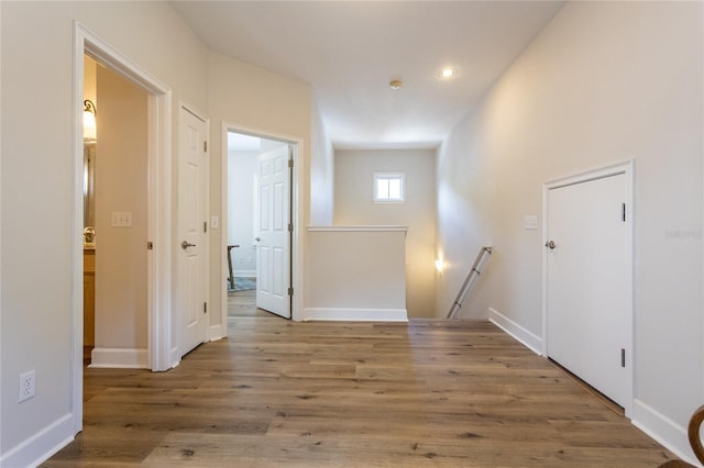 interior space with wood finished floors and baseboards