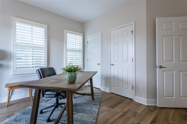 home office featuring baseboards and wood finished floors