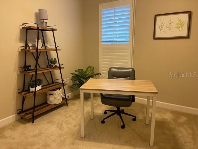 office area with light colored carpet and baseboards