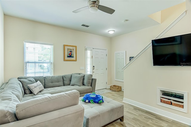 living room featuring ceiling fan and light hardwood / wood-style floors