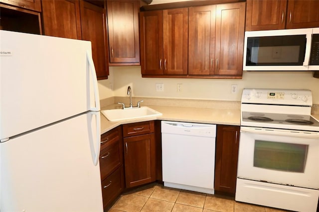 2704 NW 1st Ave, Gainesville, FL 32607 - kitchen featuring white appliances, light countertops, and light tile patterned floors