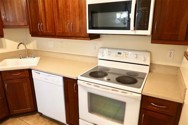 2704 NW 1st Ave, Gainesville, FL 32607 - kitchen featuring white appliances, light countertops, and light tile patterned flooring