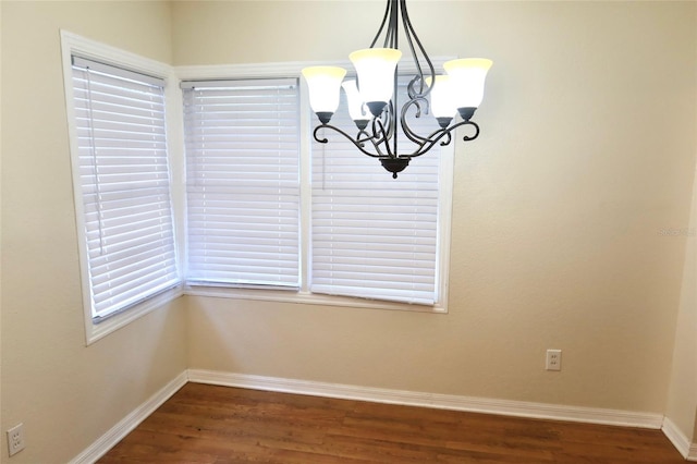 2704 NW 1st Ave, Gainesville, FL 32607 - unfurnished dining area with a chandelier and wood finished floors