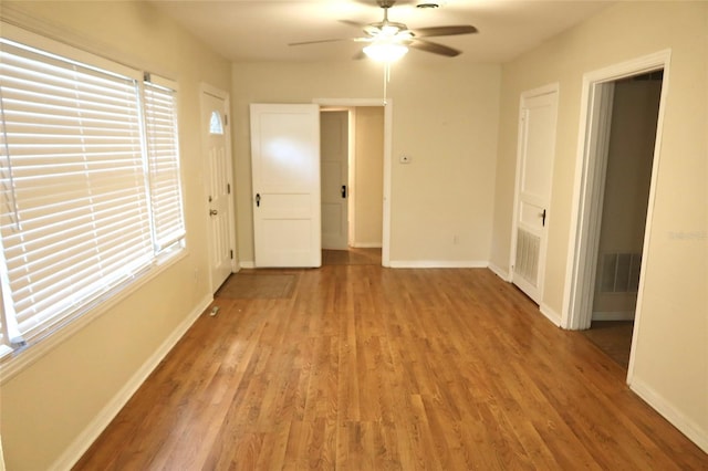2704 NW 1st Ave, Gainesville, FL 32607 - unfurnished room featuring light wood-style flooring, a ceiling fan, and plenty of natural light