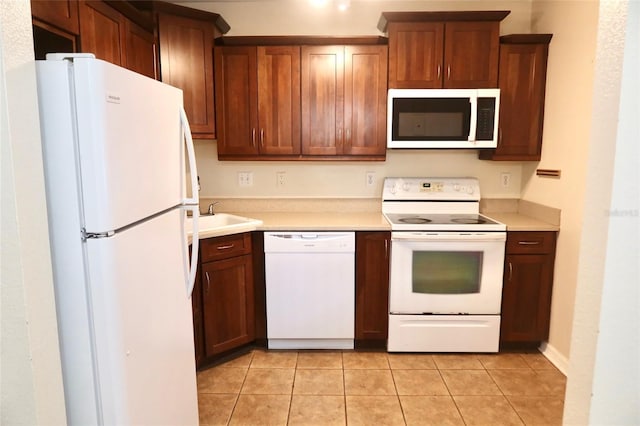2704 NW 1st Ave, Gainesville, FL 32607 - kitchen featuring white appliances, light countertops, and light tile patterned floors
