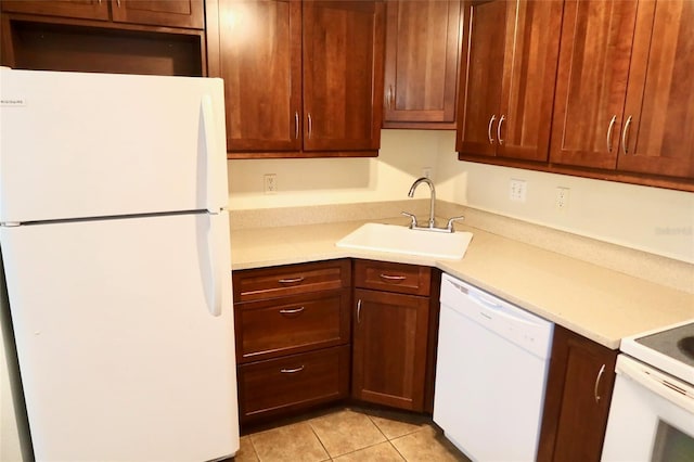 2704 NW 1st Ave, Gainesville, FL 32607 - kitchen with white appliances, light countertops, and light tile patterned flooring