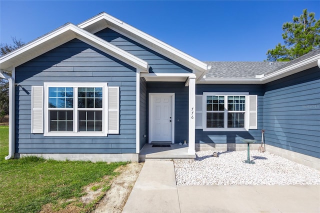 property entrance with a lawn