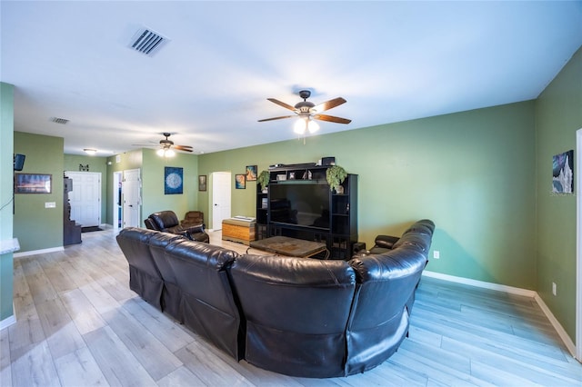 living room featuring light hardwood / wood-style flooring and ceiling fan