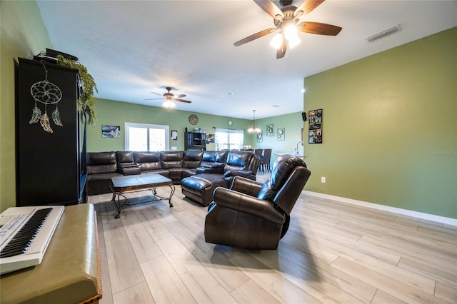 living room with ceiling fan and light wood-type flooring