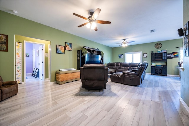 living room with ceiling fan and light hardwood / wood-style flooring