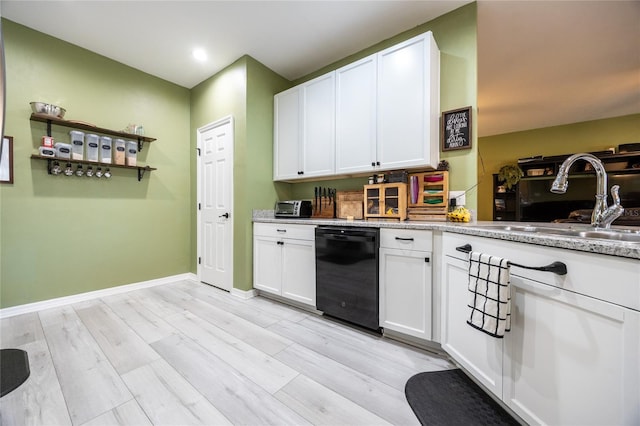 kitchen with white cabinetry, dishwasher, sink, and light hardwood / wood-style flooring