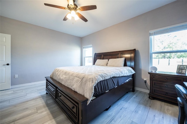 bedroom with light hardwood / wood-style flooring and ceiling fan