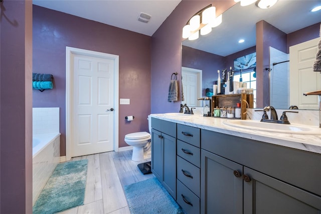 full bathroom with vanity, hardwood / wood-style floors, plus walk in shower, and toilet