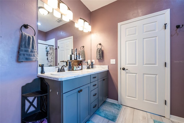 bathroom with hardwood / wood-style flooring, vanity, and a shower with curtain