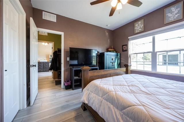 bedroom with lofted ceiling, light hardwood / wood-style flooring, and ceiling fan