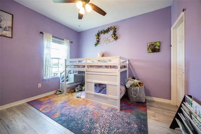 bedroom with ceiling fan and light wood-type flooring