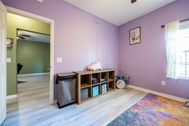 game room with light hardwood / wood-style flooring and ceiling fan