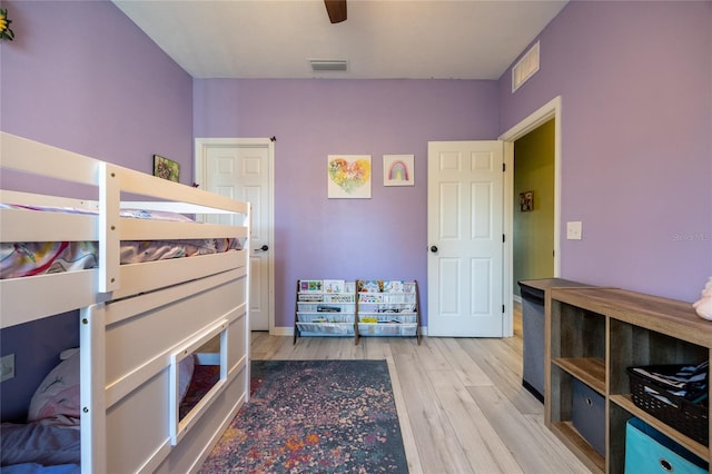 bedroom with ceiling fan and light hardwood / wood-style floors