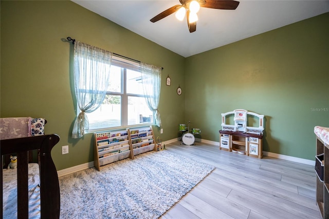 bedroom with ceiling fan and light wood-type flooring